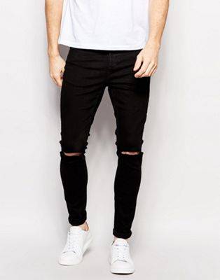 Черные джинсы с дырками на коленях, варианты модных моделей